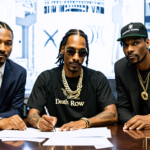 Create an image of Snoop Dogg signing a publishing agreement with executives from Death Row Records and Reservoir Media in a sleek, modern office setting. Showcase Snoop's iconic style with his tradem